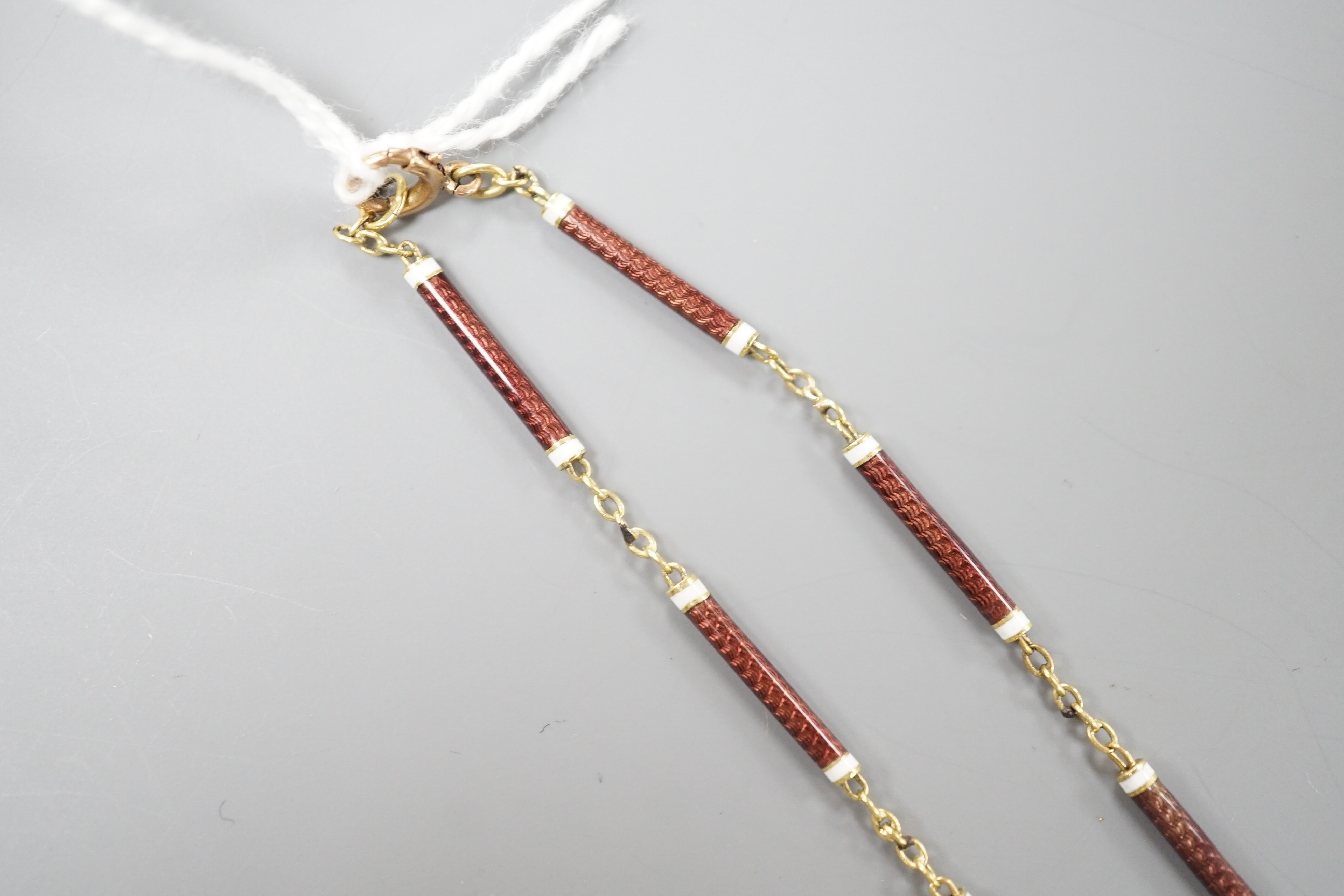 A 9ct and two colour enamelled baton link necklace, 52cm, gross 7.1 grams.